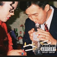 a man and woman drinking from a bottle of water